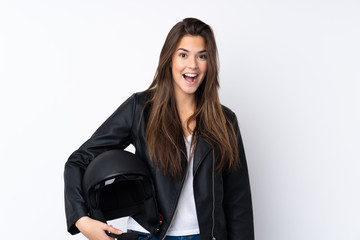 Young woman with a motorcycle helmet over isolated white background with surprise facial expression