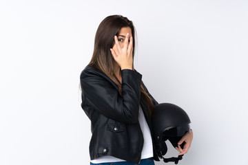 Young woman with a motorcycle helmet over isolated white background covering eyes and looking through fingers