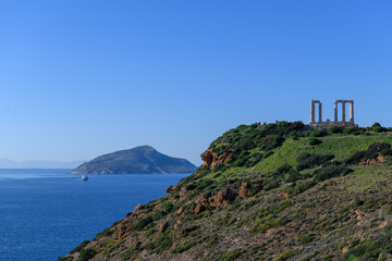 Beautiful rocky coastline and temple of Poseidon on Cape Sounion