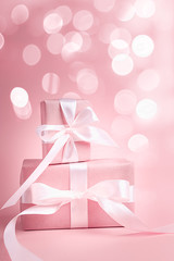 Two gift boxes on a pink background with bokeh. Valentine's day. Holiday of lovers.