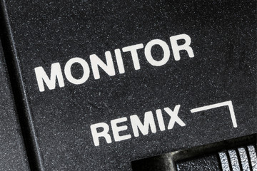 Macro close up photograph of vintage audio mixing board monitor remix control detail. 