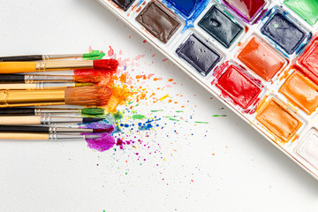 watercolor brushes on white paper