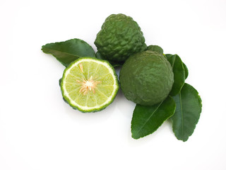 Fresh half bergamot fruits with leaf on white background.