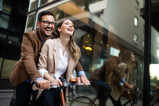 Young couple having fun in the city and ride a bicycle