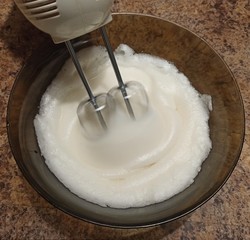 confectioner mixing bizet for cake in bowl