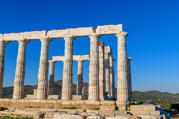 Fototapeta premium Ruins of ancient Temple of Poseidon at Cape Sounion in Attica, Greece