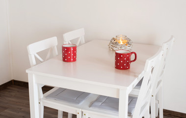 Red polka dot mugs on wooden table