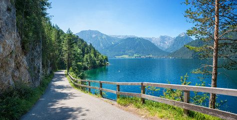 Fototapeta na wymiar walkway and bike route along lake achensee east side in idyllic mountain landscape
