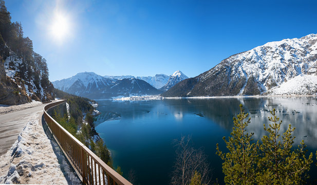 curvy lakeside road with view to lake achensee and health resort Pertisau, austrian alps in winter © SusaZoom