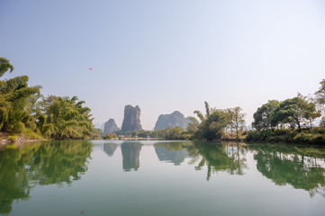 Obraz premium Lake with limestone karst hills foggy landscape reflecting in the river in Yangshuo, Guangxi province, China