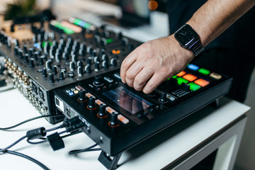 The DJ's hand on the DJ mixer