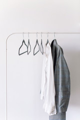 Clothes hanging against white wall. Fashion blog, website, social media hero header template.