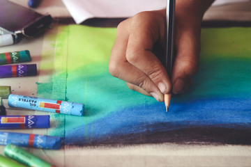 Portrait of boy drawing using color pencils and crayons 