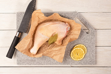 Cooking a dish of chicken meat on a cutting kitchen board made of artificial stone