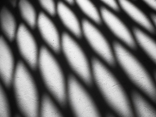 Black shadows on a white wall. Abstract background or texture.