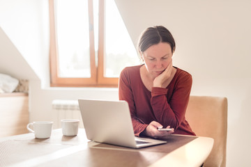 Fototapeta premium Woman telecommuting in home office interior