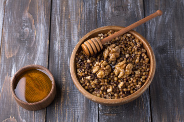 Sochivo, kutya - traditional Slavic holiday ritual dish (Russian, Ukrainian, Belarusian) of whole wheat, poppy, walnuts and honey in wooden bowl on wooden table