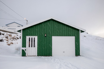 Wooden green house with snow covered in snowing on winter