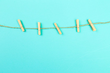 Clothes pins on a clothes line rope - four wooden pegs holding nothing - Image