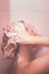 Fototapeta premium Woman washing head in shower