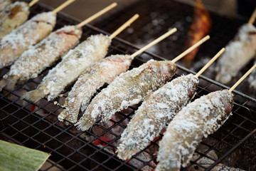 Salted fish skewer on grill 