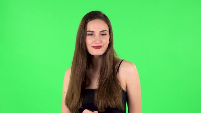 Girl is dancing on a green screen in the studio
