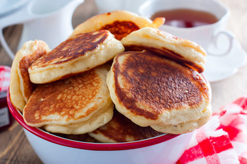 Homemade pancakes with apples on a wooden table, selective focus