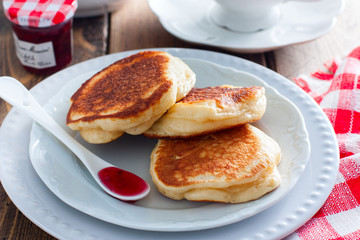 Homemade pancakes with apples on a wooden table, selective focus