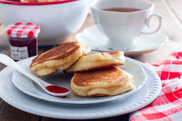 Homemade pancakes with apples on a wooden table, selective focus