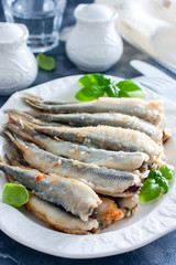 Fried smelt on a white dish, selective focus