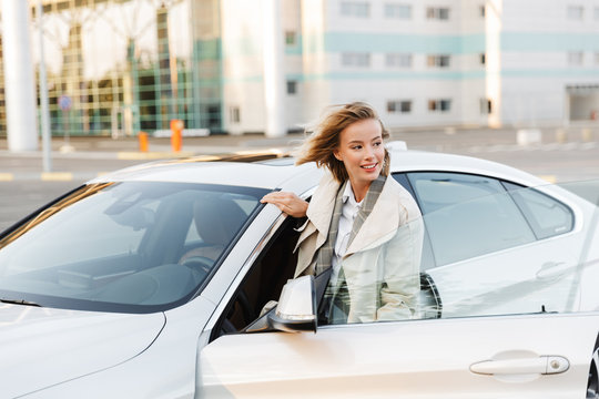 Image Of Young Beautiful Businesslike Woman Sitting In Luxury Car