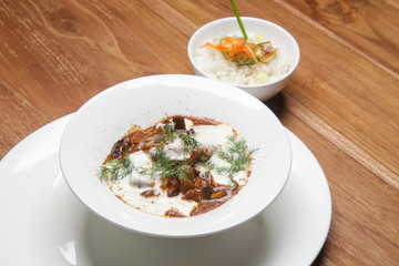 Classic beef stew with cream sauce and dill served with white rice aside	