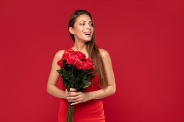 Happy smiling woman with roses bouquet.