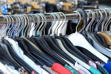 Fototapeta premium Clothing hangers on a rack with colourful summer dresses on them
