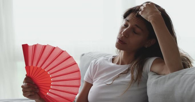 Exhausted young mixed race girl suffering from hot summer weather.