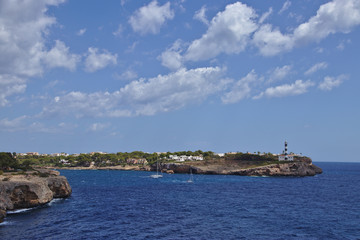 Rocky coastline with a lighthouse and residential areas