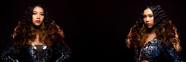 Fototapeta premium Portrait of Fashion Asian Woman has beautiful brown black long curl hair style from Stylish. Girl wears Blue Gown and swing throw her hair to side air over dark Background copy space text logo