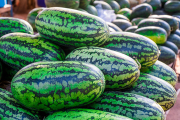 Sweet watermelon, a large number of large green organic crops on the farmers market in Thailand, Asia. Fruit for weight loss and high vitamin C.soft focus.