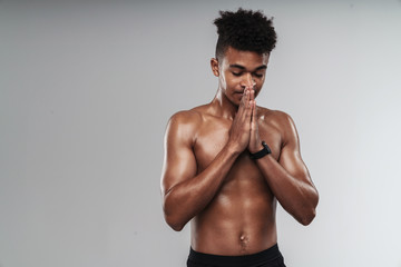 Fototapeta premium Photo of african american man posing and holding palms together