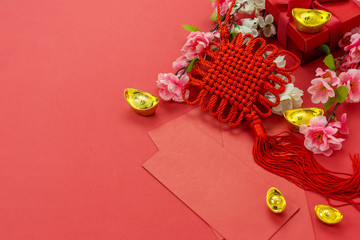 Chinese character means fortune and luck.Top view of Lunar New Year & Chinese New Year vacation concept background.Flat lay sign fortune with  pocket of money and pink cherry flower on red paper.
