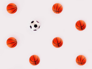 Soccer ball and basketballs on a gray background. Layout, geometric seamless pattern. The concept of sports business.