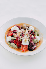  Cream cheese on a plate. Restaurant serving salad. Salad with almond shavings. Slicing fresh herbs and cherry tomatoes.