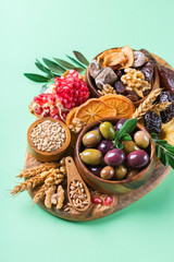 Tu Bishvat holiday symbols - dried fruits, pomegranate, barley, wheat