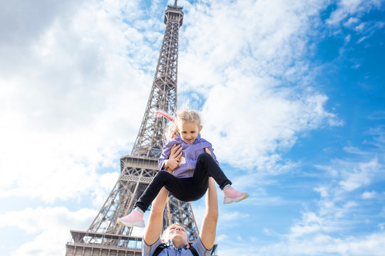 Family father and daughter happy and cheerful in Paris against the background of the Eiffel tower