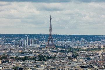 Fototapeta premium Landscape of Paris with a beautiful view from the top of the city blocks and, standing out against the roofs, the Eiffel tower