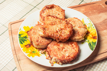 Fried fish fillet pollack in plate on wooden board.