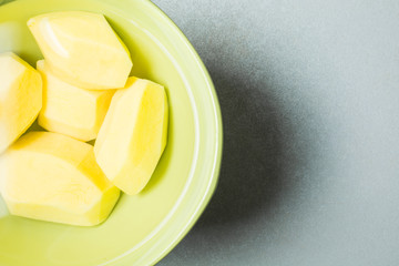 Peeled new potatoes in deep dish with water to remove nitrites.
