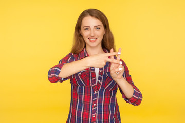 Viral web content. Portrait of cheerful attractive ginger girl in casual shirt showing hash sign, hashtag hand gesture, popular topic, recommendation on internet. indoor studio shot, yellow background