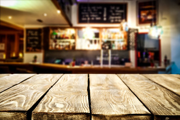 Desk of free space for your decoration and blurred bar background 