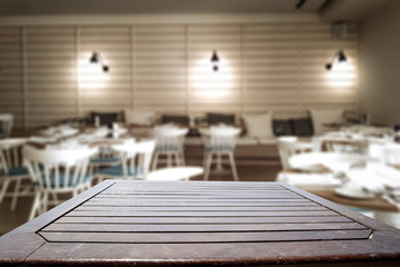 Desk of free space for your decoration and blurred bar background 